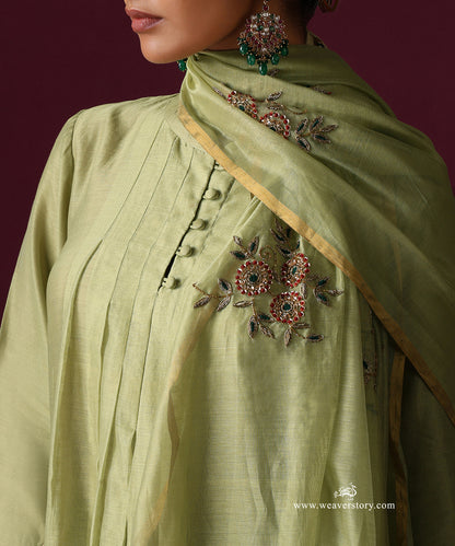 Detail of floral zardozi embroidery with red and green accents on the pista green dupatta