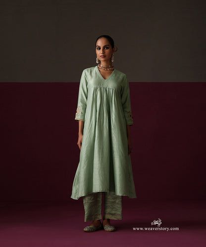 Front view of the gathered sage green kurta and striped Chanderi tissue pants
