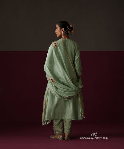 Back view of the sage green Chanderi suit with embroidered dupatta and striped tissue pants