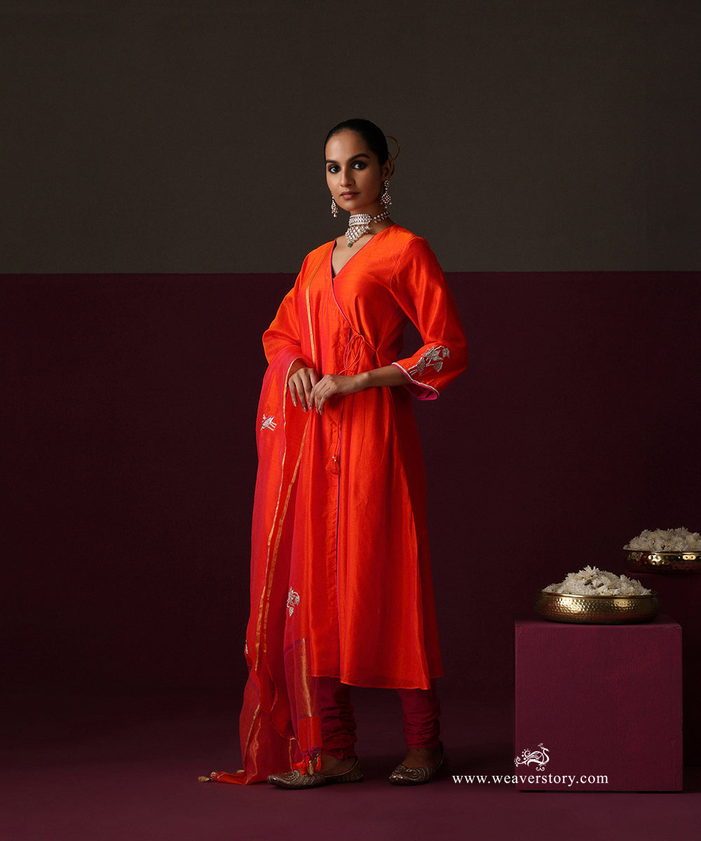Model wearing Nilofer, an orange Chanderi Angrakha with lotus embroidered dupatta and hot pink churidar