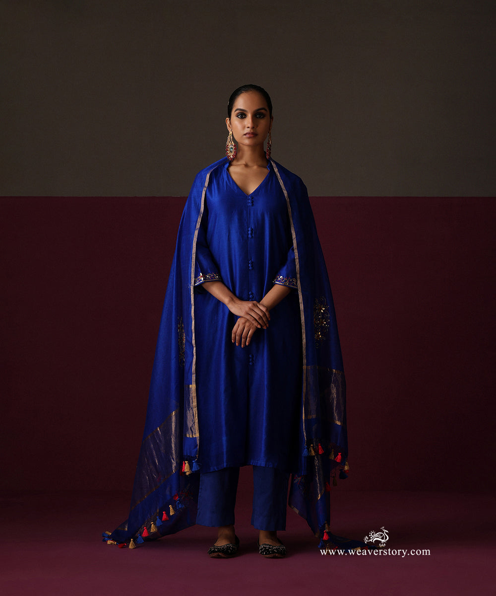 Royal blue Chanderi pants beneath a kurta, with gold-striped dupatta ends and colourful tassels