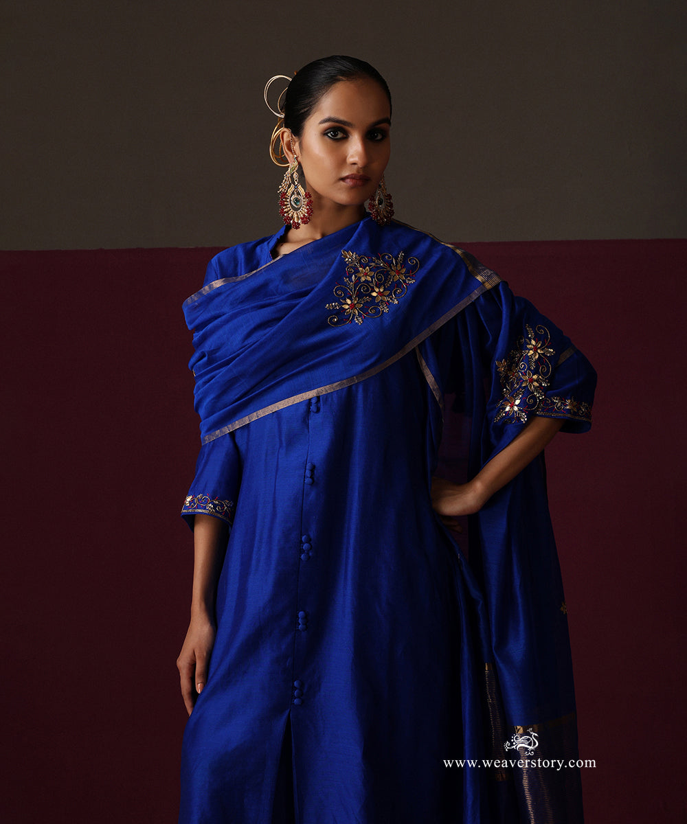 Royal blue Chanderi suit with an embroidered dupatta draped across the shoulder