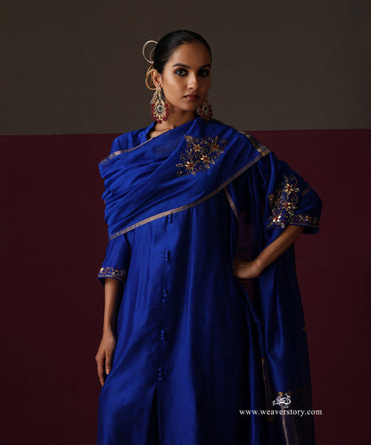 Royal blue Chanderi suit with an embroidered dupatta draped across the shoulder