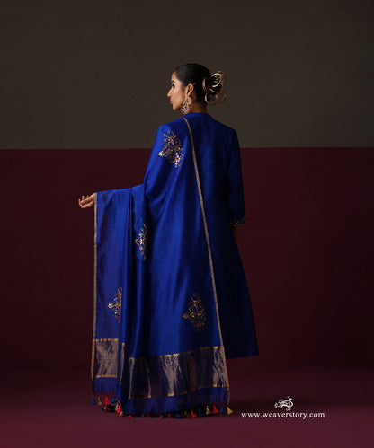 Back view of the royal blue suit with a floral embroidered dupatta and tasselled ends