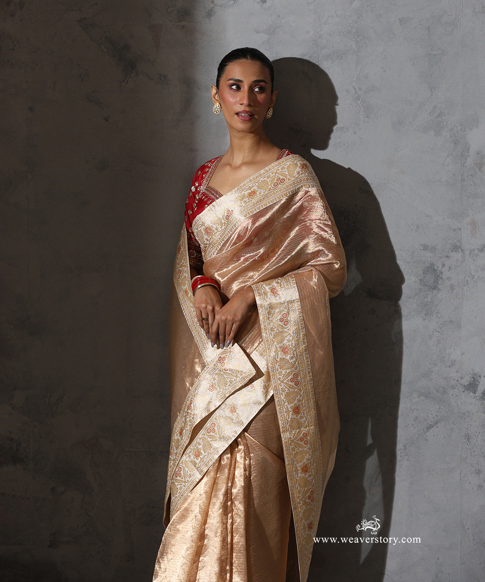 Padmika gold Tissue Organza saree with vintage Katan silk Banarasi border featuring zari, floral and paisley motifs with meenakari accents.