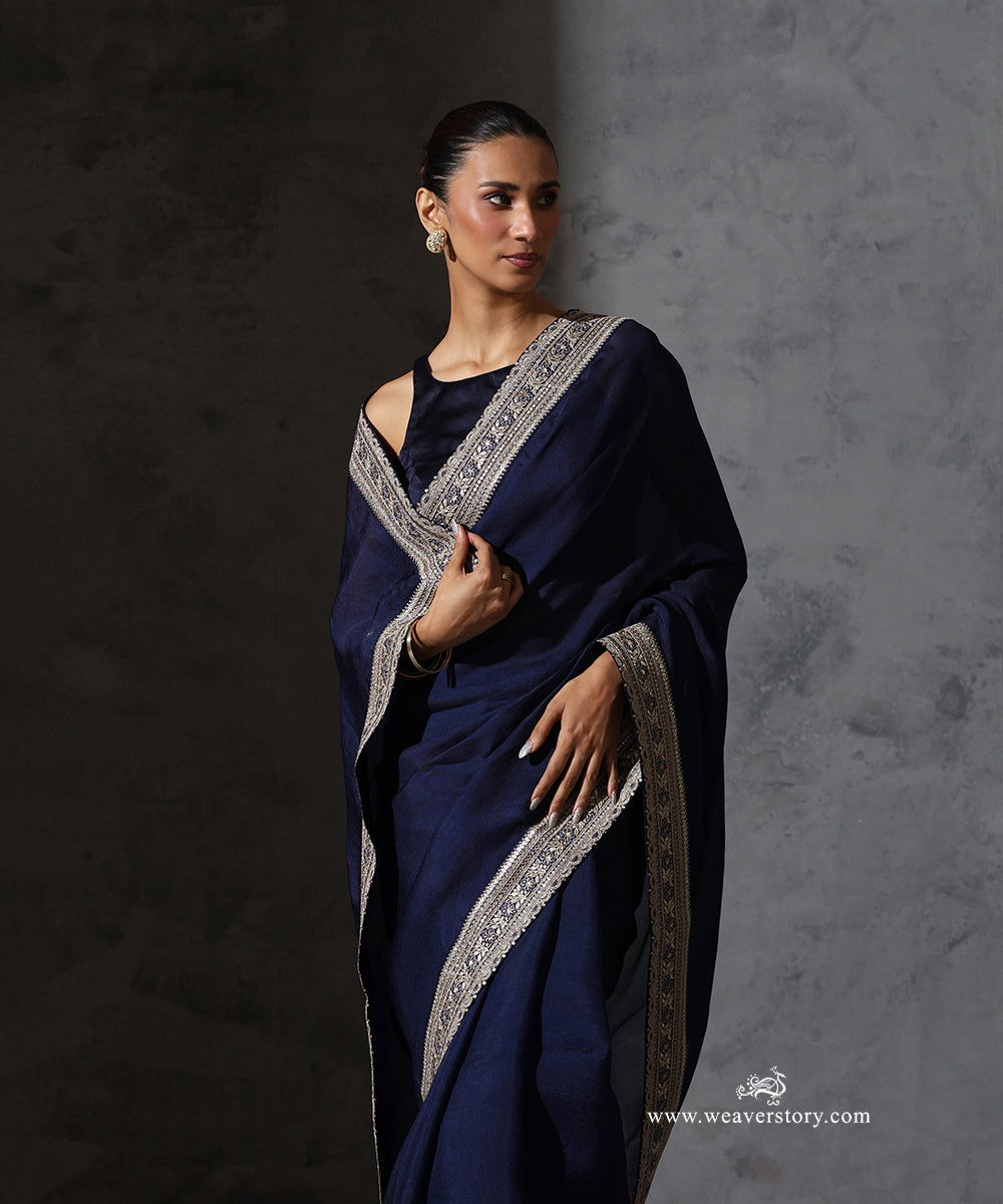 Front detail of Tarini navy blue pure silk organza saree showing the fine floral thread and zari embroidery along the border.