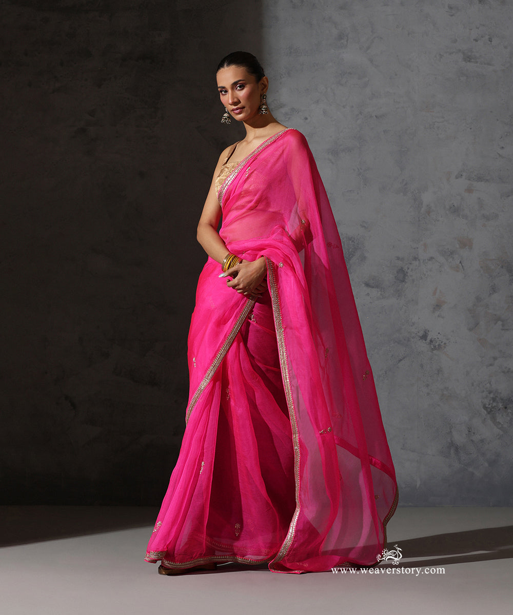 Full view of Tarini hot pink pure silk organza saree with hand-embroidered zardozi bootis and fine border.