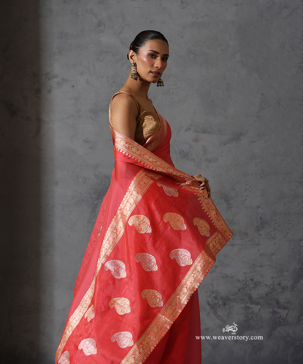 Mrinalika coral pink pure silk organza saree with hand-embroidered zardozi motifs and vintage Banarasi zari border.