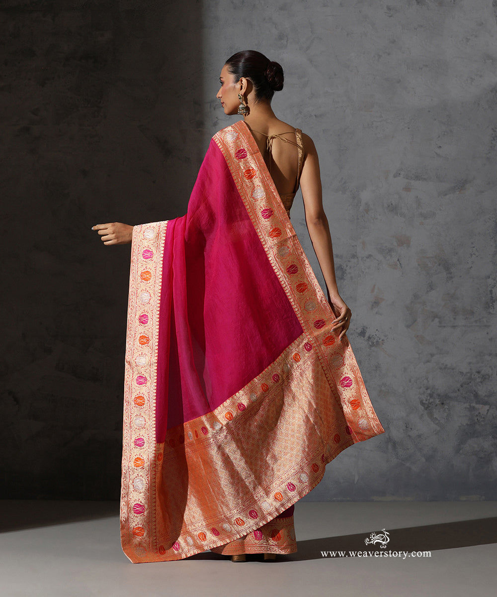 Back view of Tilottama magenta organza saree showing the broad zari-woven pallu and vintage meenakari Banarasi border.