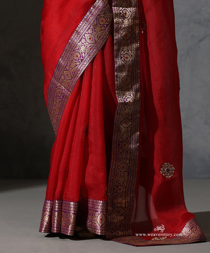 Close-up of Kaushiki red pure silk organza saree with hand-embroidered zardozi meenakari bootis and contrast purple vintage Banarasi zari border.