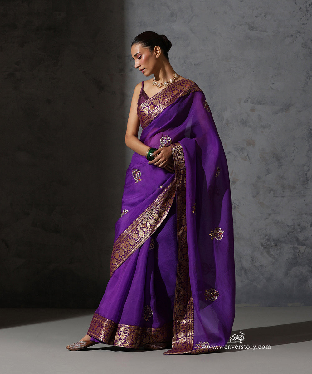 Draped view of Vaijayanti purple organza saree highlighting hand-embroidered meenakari bootis and ornate vintage Banarasi border.