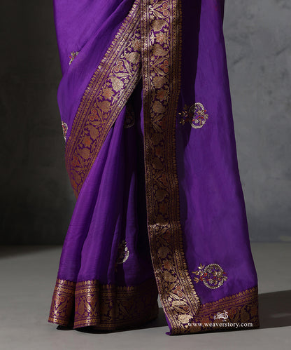 Detail of Vaijayanti purple organza saree showing hand-embroidered meenakari bootis and vintage Banarasi border with paisley and floral motifs.