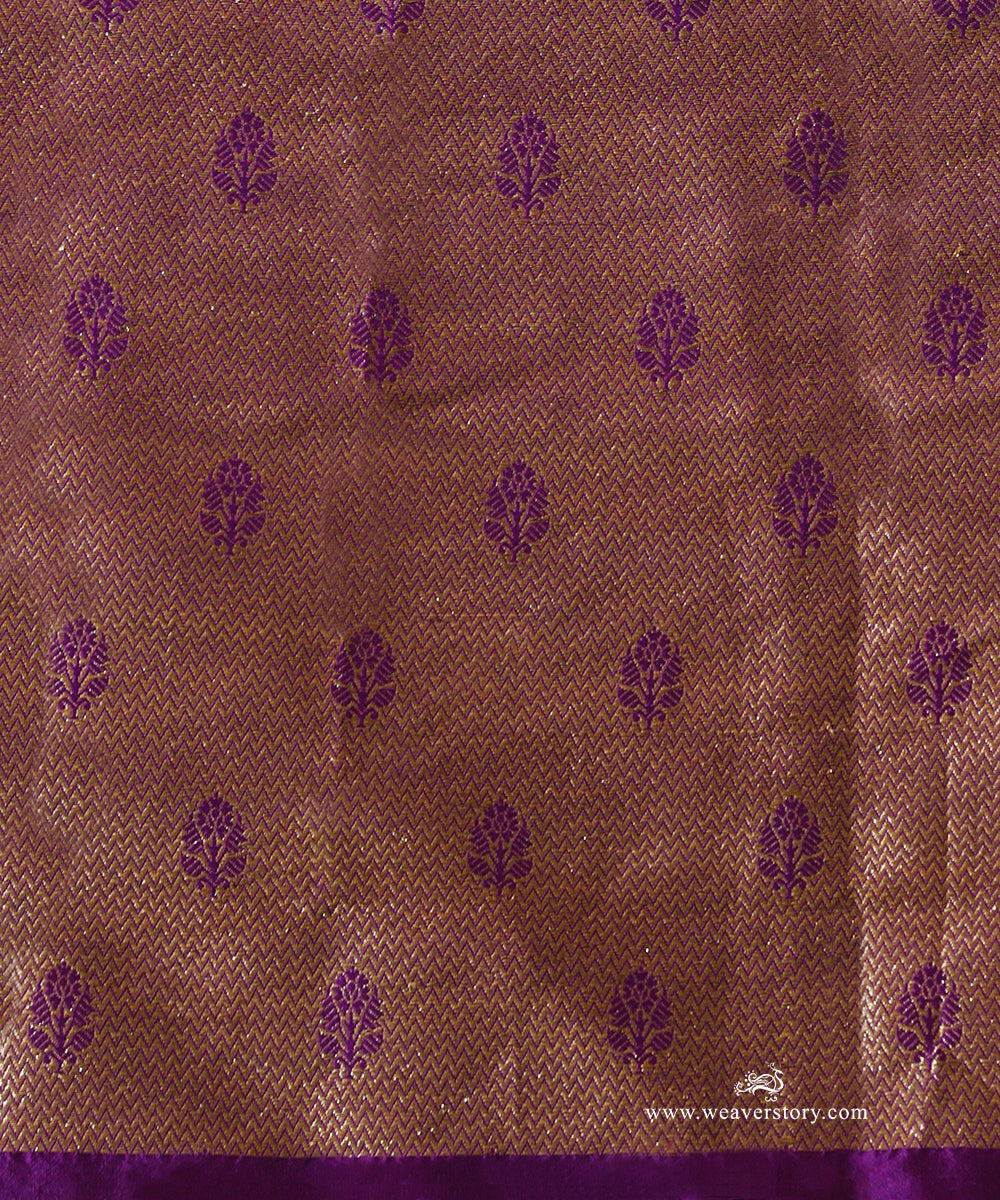 Close-up of brocade blouse fabric paired with Vaijayanti purple organza saree, showing fine zari weave and floral motifs.