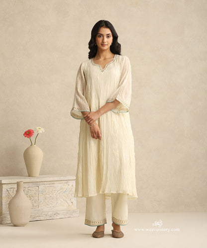 Ivory_Handloom_Mul_Chanderi_Suit_Set_With_Hand_Embroidery_And_Blue_Piping_WeaverStory_03
