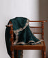 Dark bottle green handloom organza dupatta draped over a wooden chair, showing its rich colour and intricate metallic zardozi border.