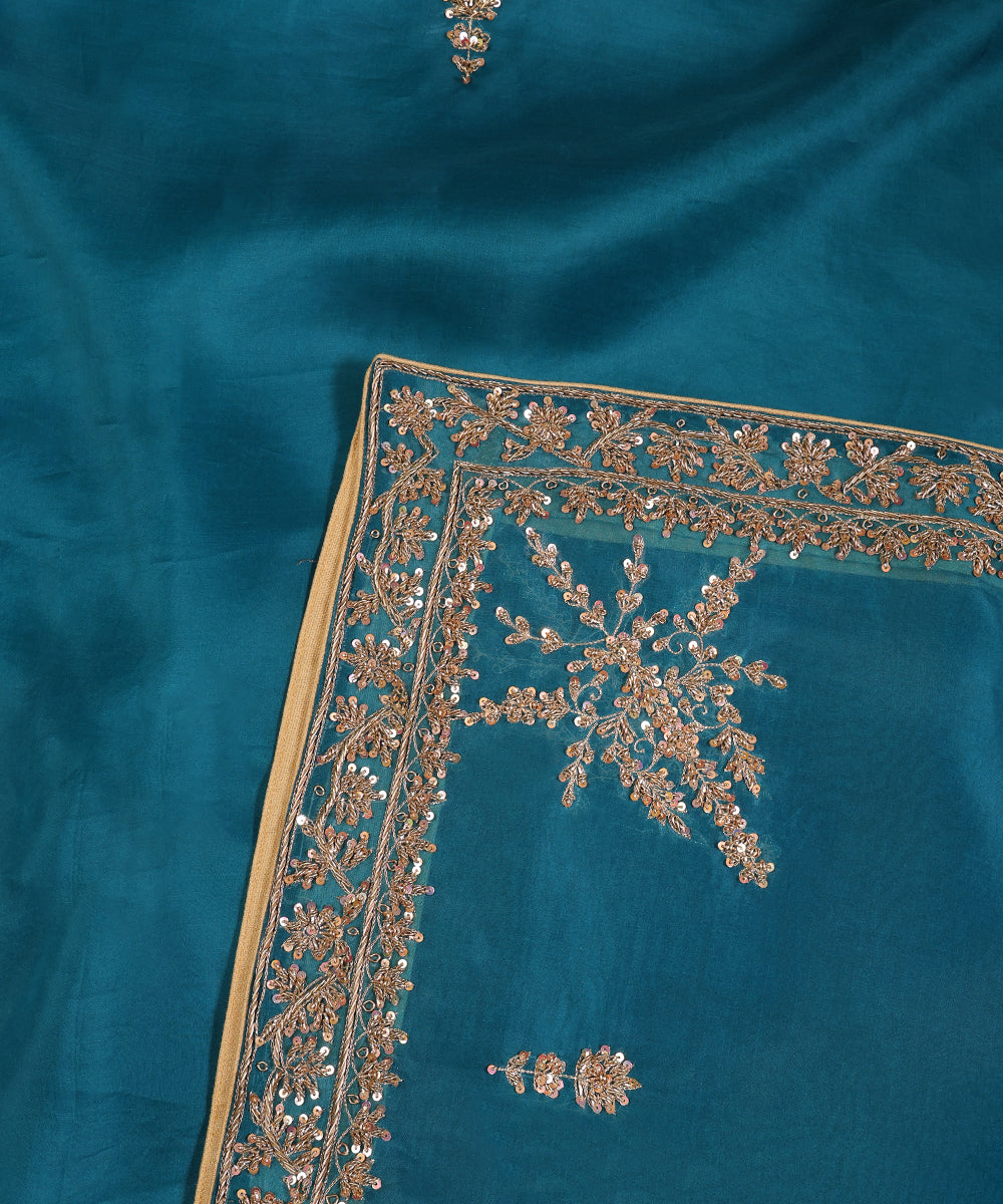 Close-up of Firozi blue organza dupatta with fine zardozi floral vines, sequin accents and an elaborate floral corner motif