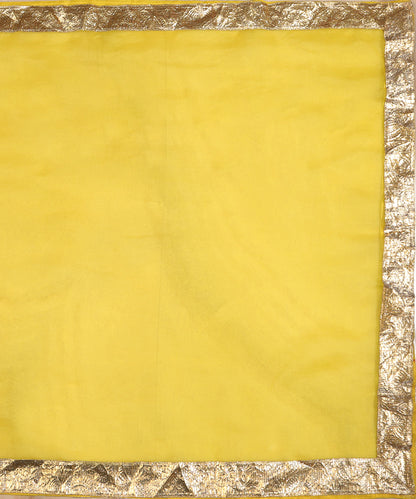 Full view of yellow silk organza dupatta with a broad handcrafted metallic lampi gota border on all four sides