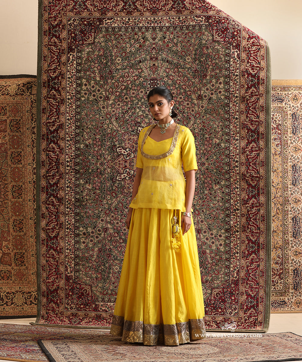 Yellow Chanderi silk lehenga set with pure silk organza hand embroidered overlay top and antique gold lampi gota border by WeaverStory