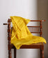Yellow striped Tissue Chanderi dupatta draped over a wooden chair, showing its lightweight texture and metallic zari lines.