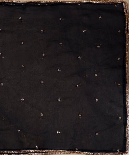 Full view of black organza dupatta with delicate gold zardozi bootis placed across the sheer surface.