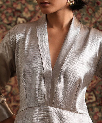 Close-up of silver chevron brocade dress with structured V neckline