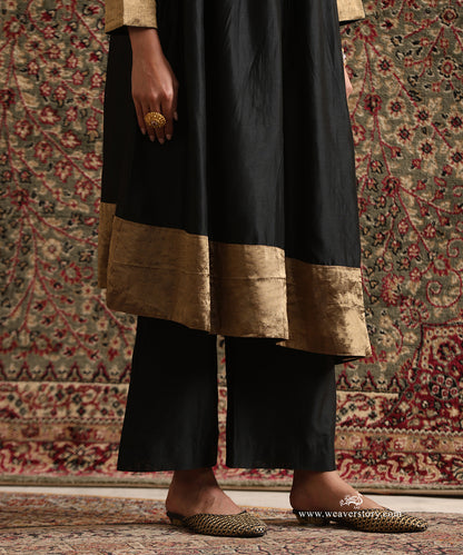 Detail of the Black Pure Chanderi Silk High-Low Kurta showcasing the broad gold tissue hem and plain wide-leg pants