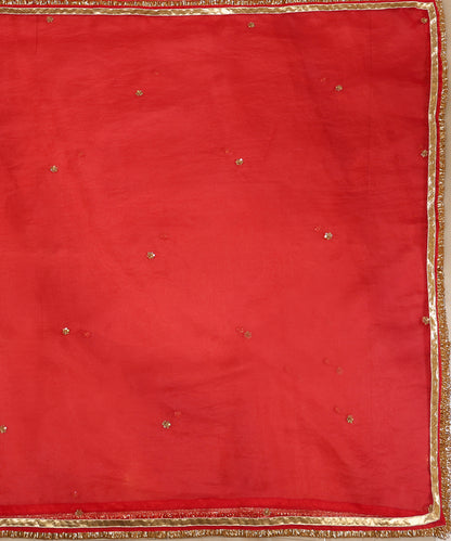 Full view of red silk organza dupatta with evenly spaced zardozi bootis, gleaming lampi gota and kiran-finished edges.