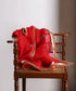 Close-up of red organza dupatta with hand-embroidered zardozi farisha bootas, gleaming gota and metallic kiran edging.