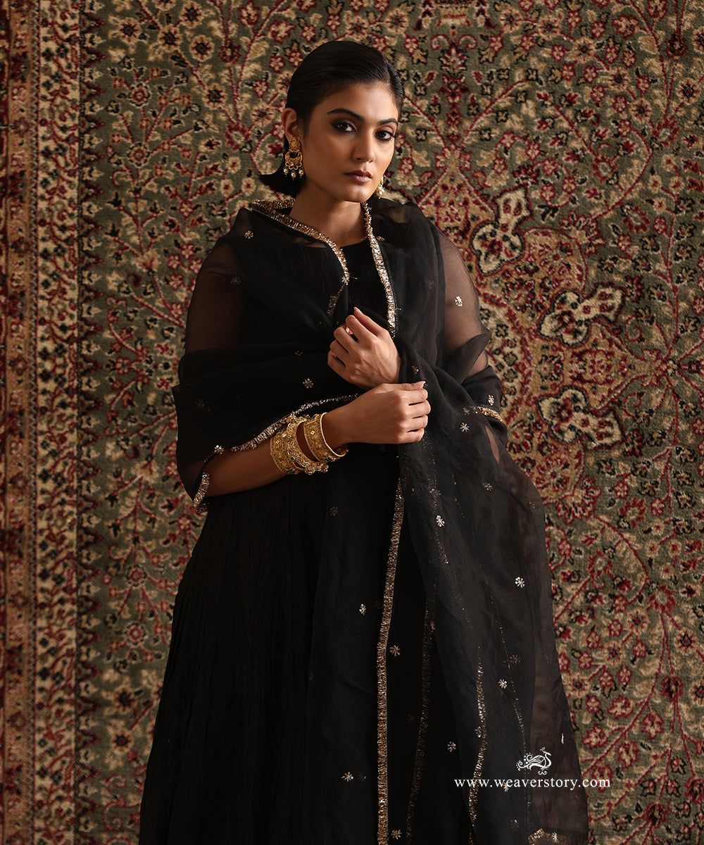 Black pure Chanderi silk wrinkled Anarkali styled with a pure silk organza dupatta featuring hand embroidered floral motifs and a handcrafted kiran border