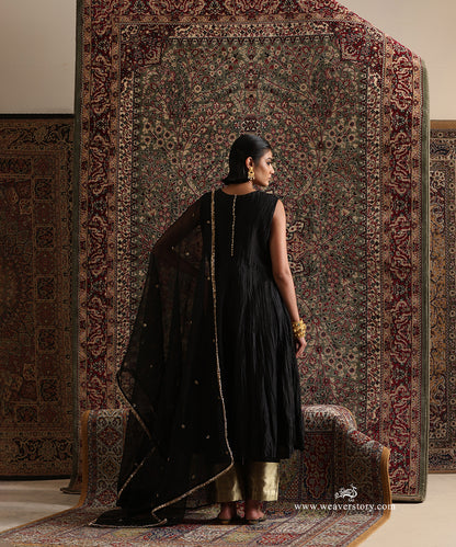 Back view of black pure Chanderi silk wrinkled Anarkali with cotton silk pants featuring a gold brocade border and pure silk organza dupatta