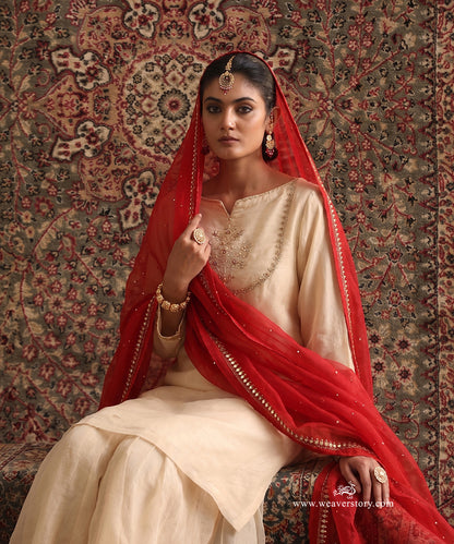Almond Beige Organza Silk kurta and gharara set styled with contrasting red embroidered organza silk dupatta