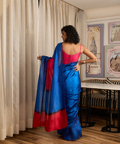 Cobalt blue pure silk Arashi Shibori saree with vibrant hot pink accents and a bold contrasting pallu.