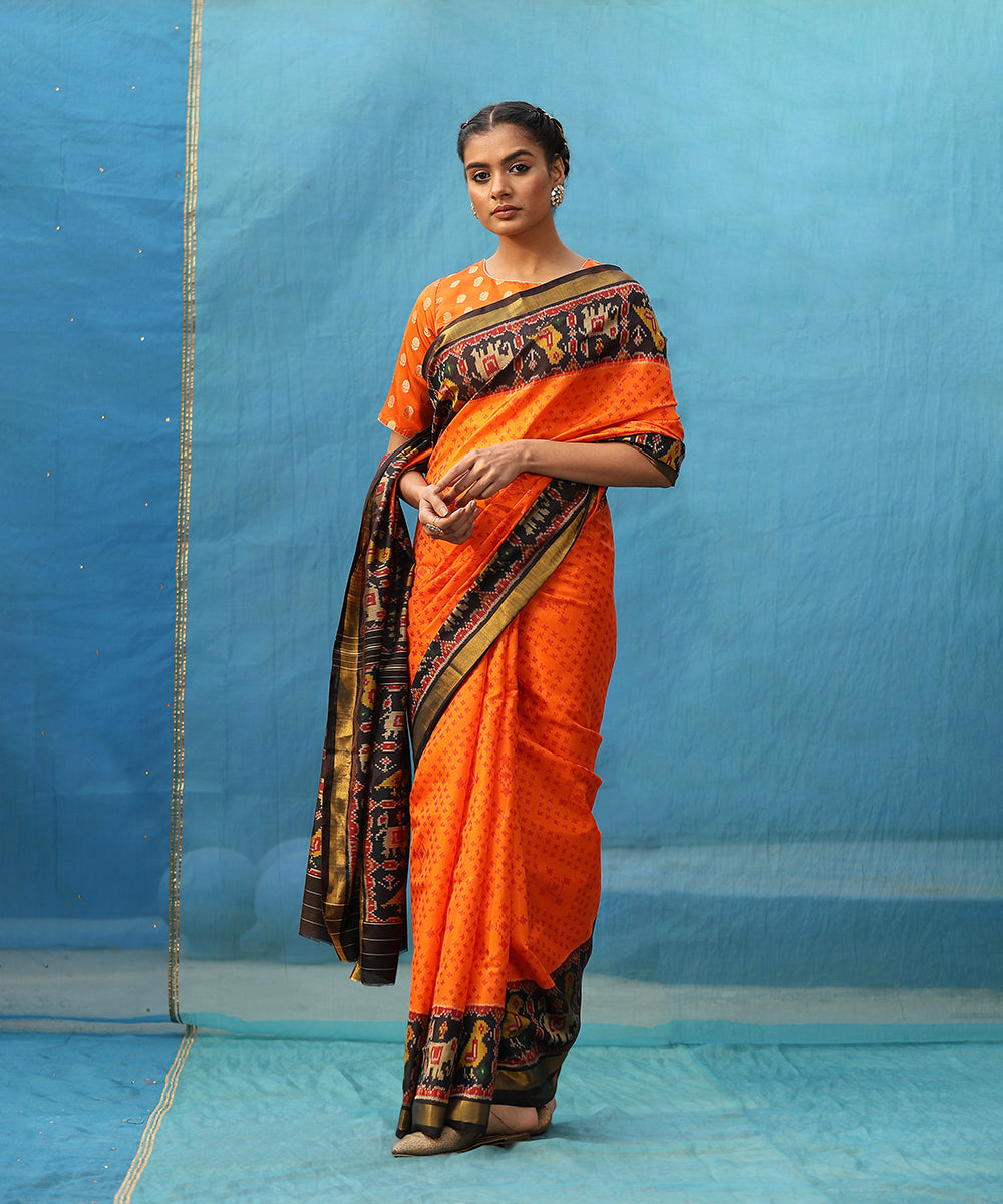 Orange_And_Black_Handloom_Pure_Mulberry_Silk_Ikat_Patola_Saree_With_Black_Border_And_Palla_WeaverStory_01