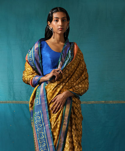 Mustard_Handloom_Pure_Mulberry_Silk_Ikat_Patola_Saree_With_Blue_Border_WeaverStory01