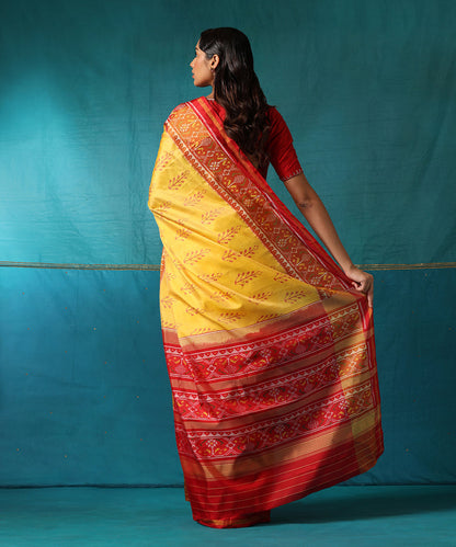 Yellow_And_Red_Handloom_Pure_Mulberry_Silk_Ikat_Patola_Saree_With_Tree_Motifs_WeaverStory03