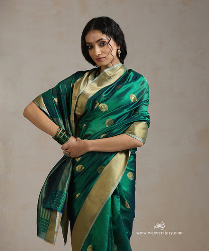 Handloom_Peacock_Green_Silk_Chanderi_Saree_With_Rangoli_Boota_And_Gold_Saffron_Border_WeaverStory_01