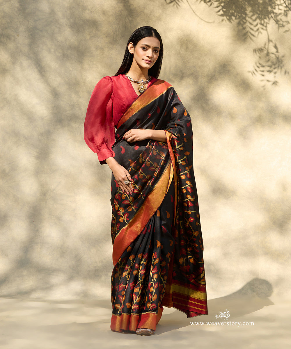 Black_Handloom_Pure_Mulberry_Silk_Ikat_Patola_Saree_With_Big_Peacock_Motif_On_Pallu_And_Gold_Zari_Border_WeaverStory_01