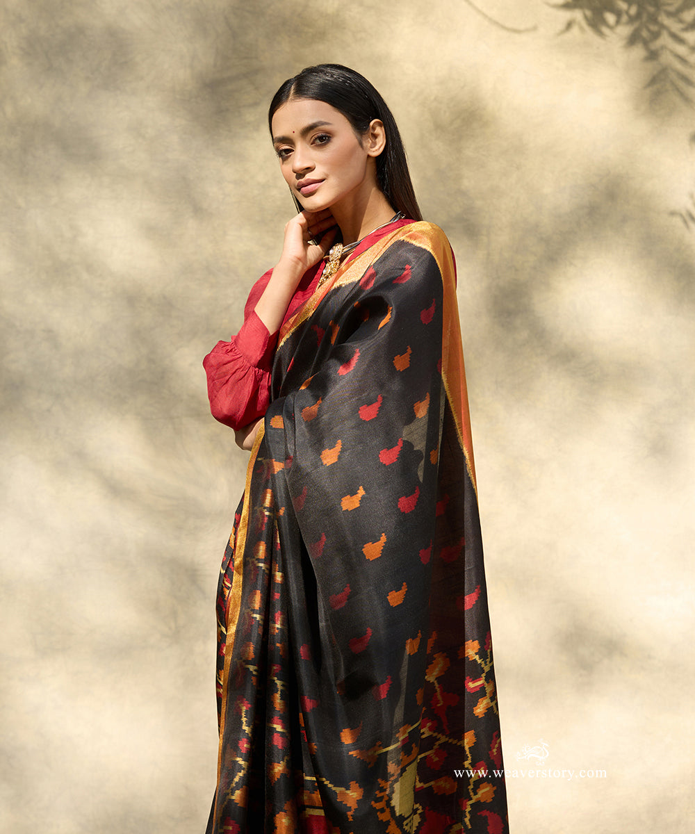 Black_Handloom_Pure_Mulberry_Silk_Ikat_Patola_Saree_With_Big_Peacock_Motif_On_Pallu_And_Gold_Zari_Border_WeaverStory_02