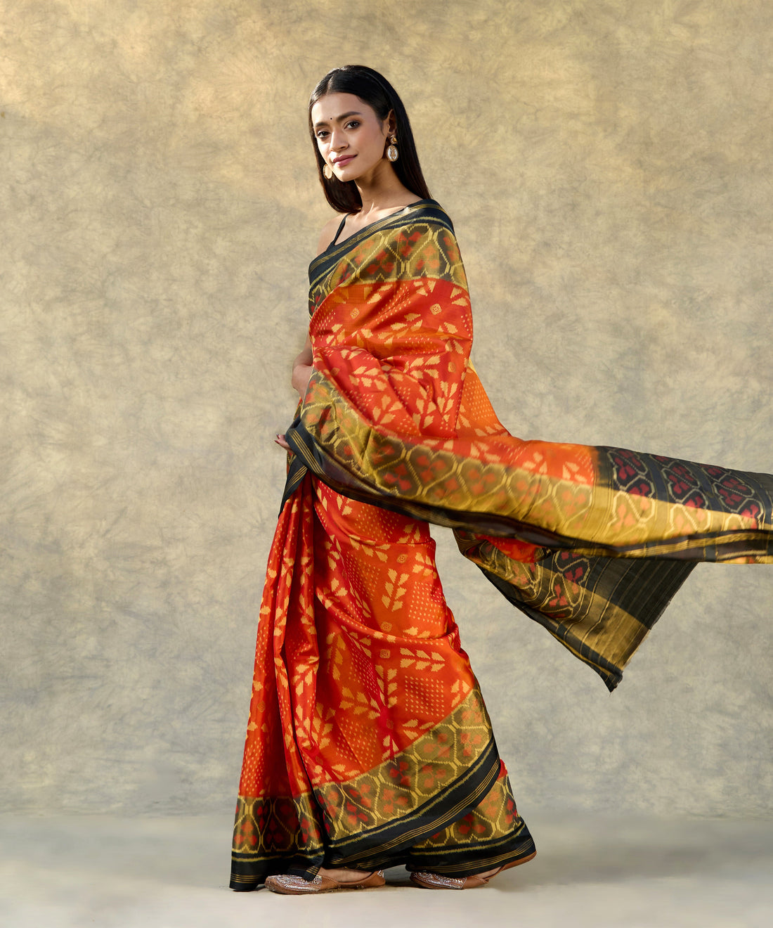 Orange_Handloom_Pure_Mulberry_Silk_Ikat_Patola_Saree_With_Black_Pallu_And_Tissue_Border_WeaverStory_01