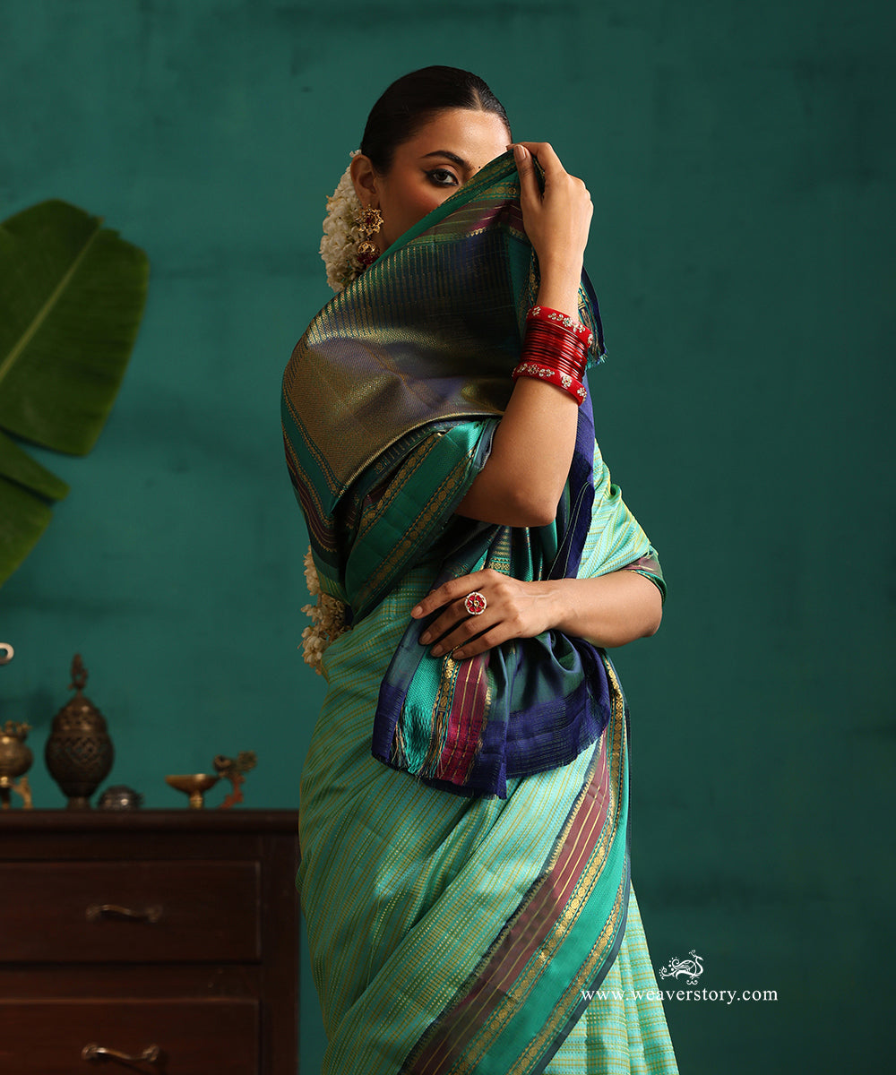 Aqua_Green_Handloom_Pure_Silk_Kanjivaram_Saree_With_All_Over_Zari_Small_Stripes_And_Green_And_Wine_Korwai_Border_WeaverStory_02