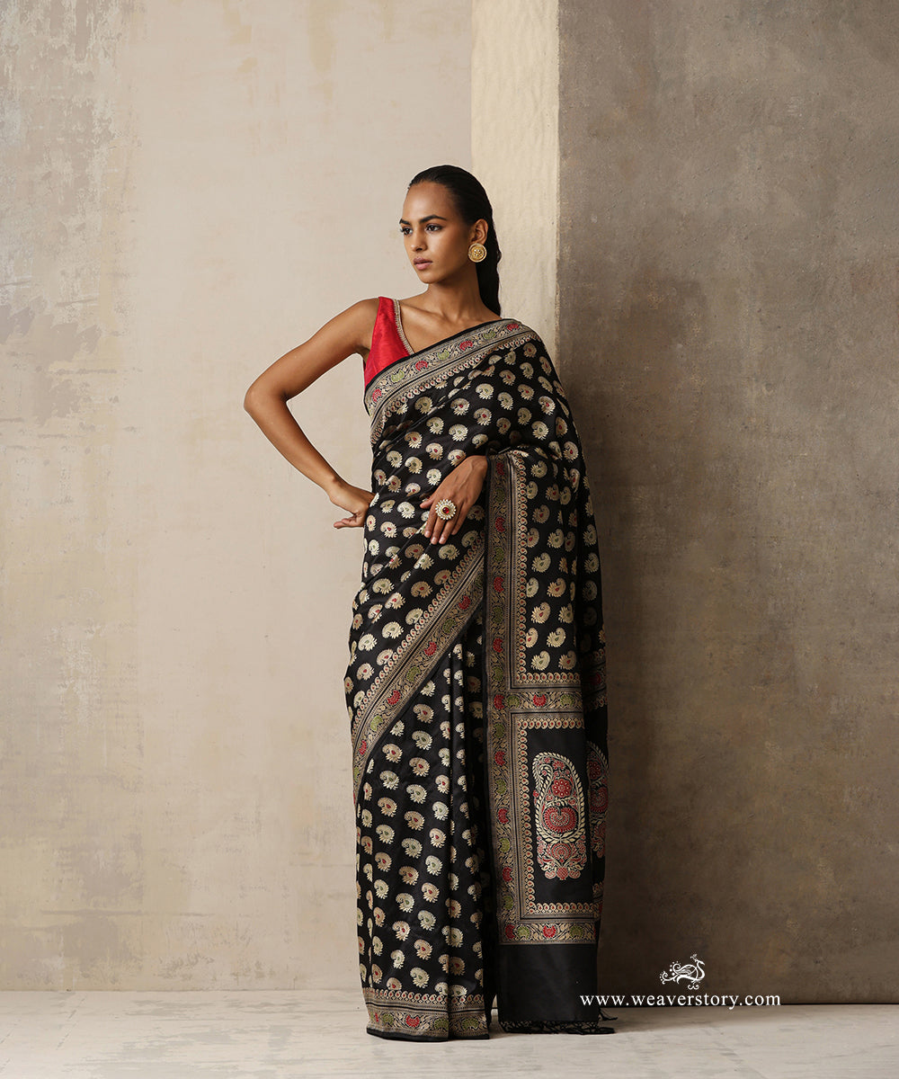 Black handwoven pure Malda silk Baluchari Banarasi saree with Kadhwa weave, floral silk bootis, intricate woven borders and statement kalka pallu by WeaverStory.