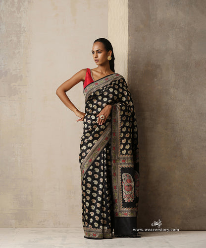 Black handwoven pure Malda silk Baluchari Banarasi saree with Kadhwa weave, floral silk bootis, intricate woven borders and statement kalka pallu by WeaverStory.