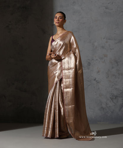 Full front view of champagne pink Banarasi tissue saree styled with a plum blouse