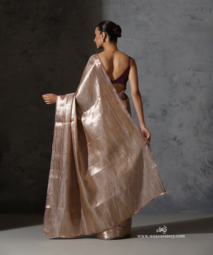 Back view showing the woven Tanchoi pallu and zari border of the champagne pink Banarasi tissue saree