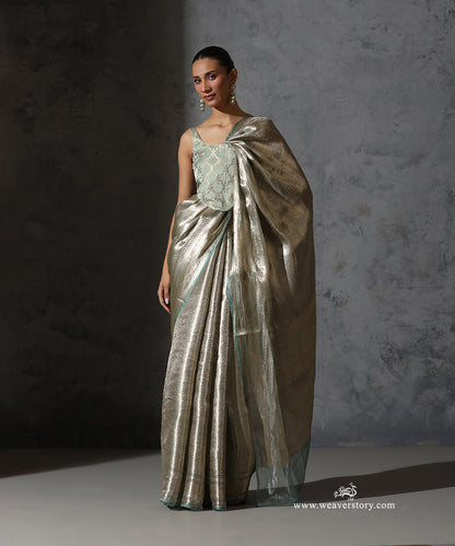 Full front view of mint green and gold Banarasi tissue saree with zari border