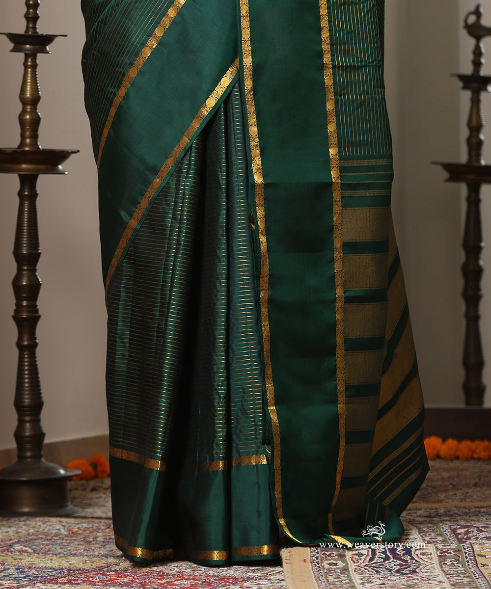 Bottle Green Handloom Pure Silk Kanjivaram Saree With Allover Horizontal Golden Zari Lines And Golden Border