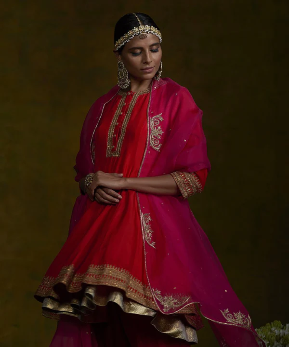 Red short gherdaar kurta and salwar set with pita zardozi work and pink embroidered dupatta