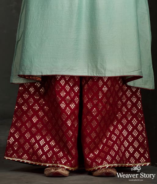 Hand_front_boota_embroidered_munga_silk_suit_in_light_blue_color_with_brocade_palazzo_WeaverStory_04