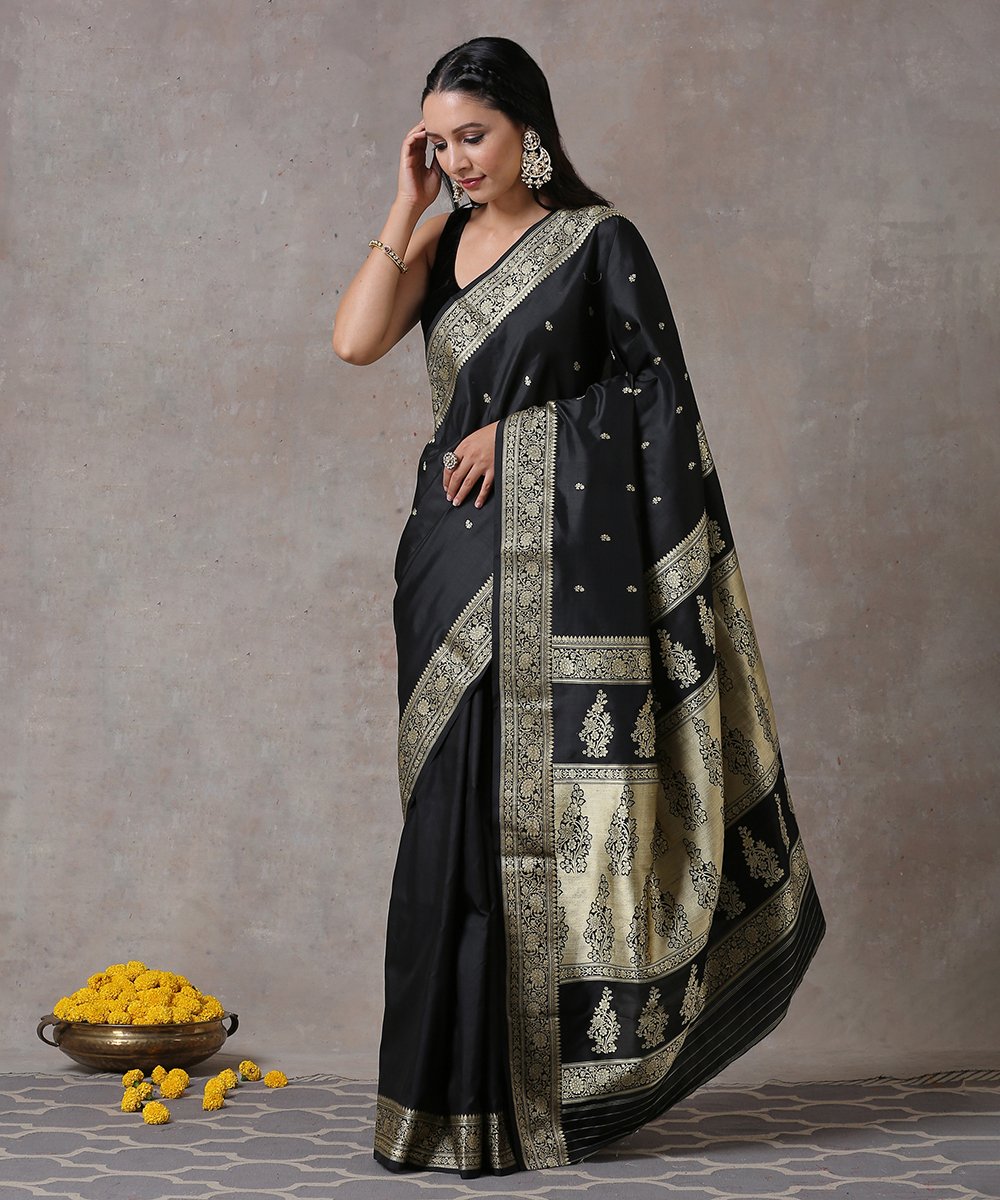 black pure katan silk saree. paired with ivory embroidered cowl top with  embroidered velvet tie-knot belt Design by Neha & Tarun at Modvey