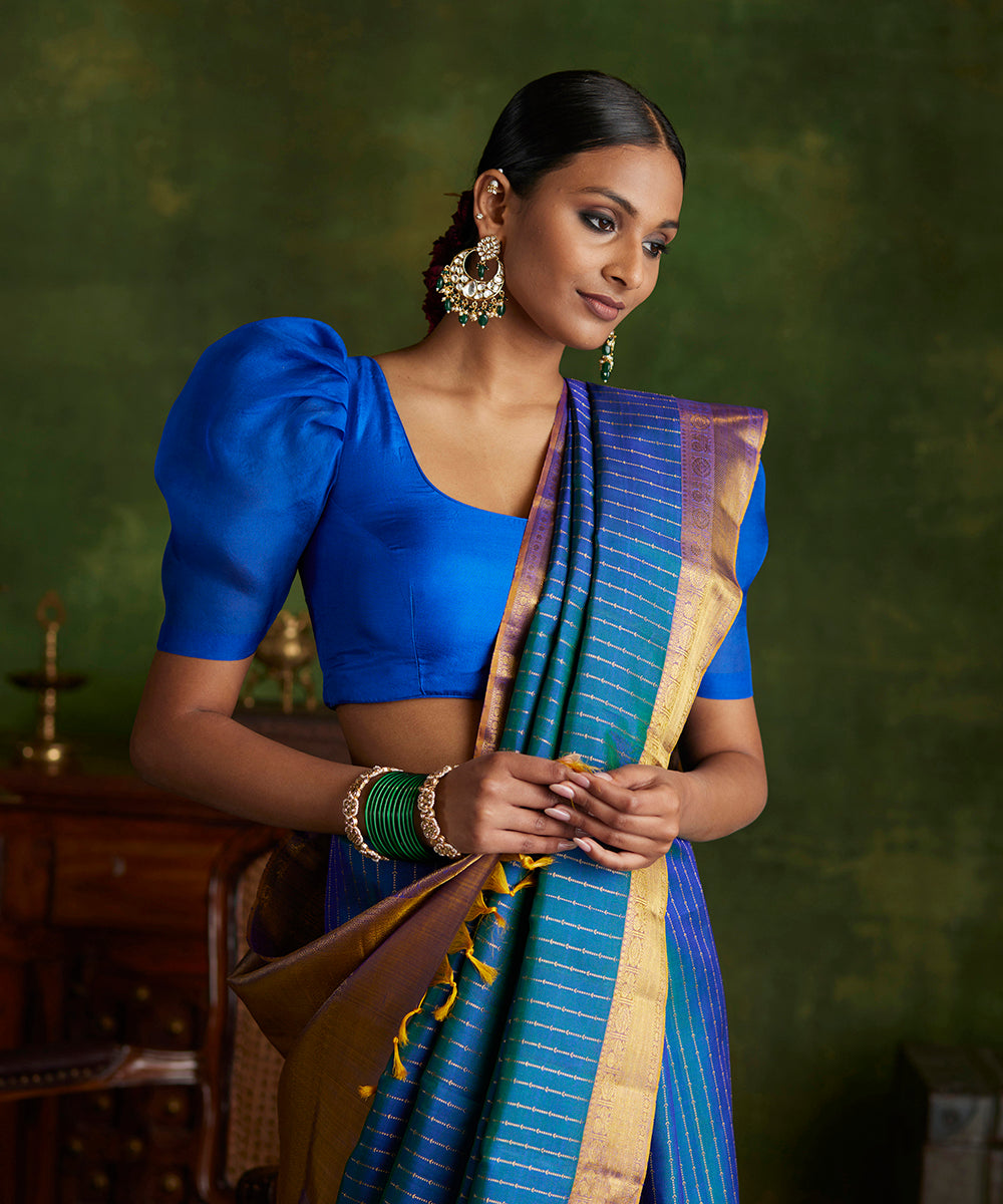 Peacock_Blue_Handloom_Pure_Zari_Kanjivaram_Saree_With_Purple_And_Gold_Border_WeaverStory_01